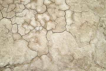 A top down shot of a dry lake bottom full of texture.The cracks form a distinctive lightning like...