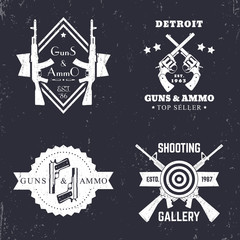 guns and ammo, vintage logo, badge with automatic rifles, crossed revolvers, two pistols, shooting gallery logo, sign with assault