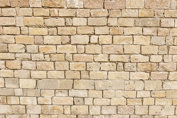 Old beige stone wall background texture