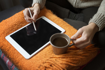 Fototapeta na wymiar Woman Using Digital Tablet And Drinking Coffee At Home