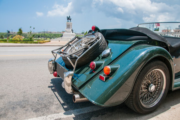 beautiful vintage cars parked along the malecon