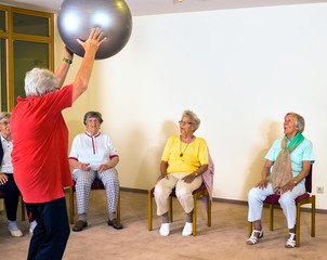 Instructor working with senior ladies in a gym.