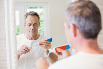 Fototapeta premium Handsome man brushing his teeth