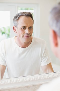 Handsome Man Looking At Himself In The Mirror