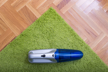 Handheld vacuum cleaner on the carpet