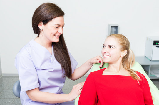Friendly and trustworthy dentist woman and patient