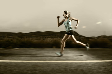 young fit sport woman running outdoors on asphalt road in mountain landscape background fitness and healthy lifestyle
