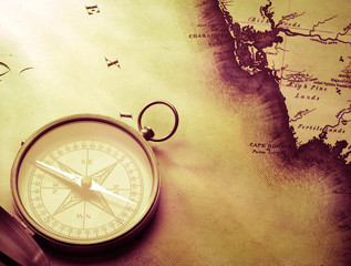 antique compass on vintage map background