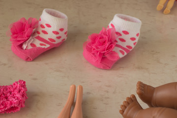 Pink polka dot baby socks and legs of dolls