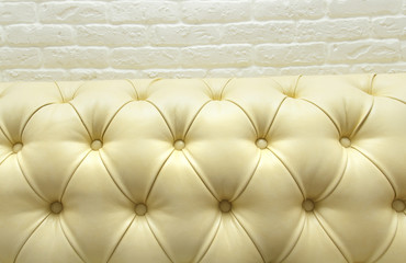 Leather upholstery of a magnificent sofa,decorative brick masonr