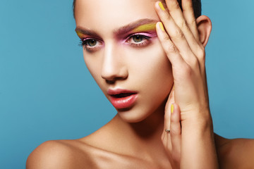 Portrait of beautiful girl with colorful makeup
