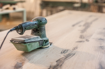 Electric Sander / Carpenter sanding a wood with sander