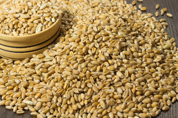 The grains of wheat in a box on the table closeup