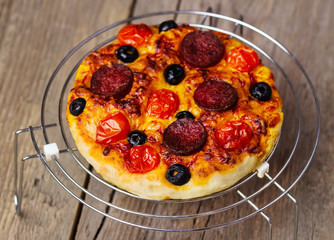 hot homemade pizza  with cheese, tomatoes, olives, sausage