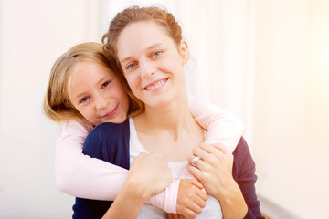 Obraz na płótnie Canvas Young girl hugging his sister