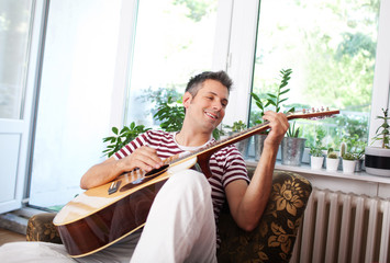 Playing acoustic guitar