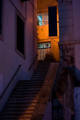 Old stairs. Light and shadows on a stone building and stairway in a quiet corner of old district Alfama in Lisbon, Portugal