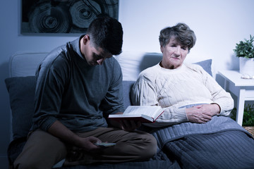 Fototapeta premium Busy grandson reading book