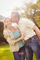 Fototapeta premium Husband kissing wife on the cheek