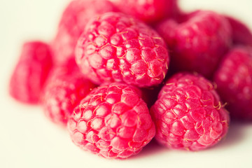 juicy fresh ripe red raspberries on white
