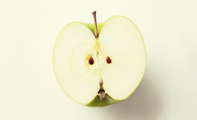 ripe green apple half over white