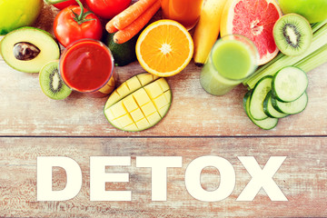 close up of fresh juice glass and fruits on table
