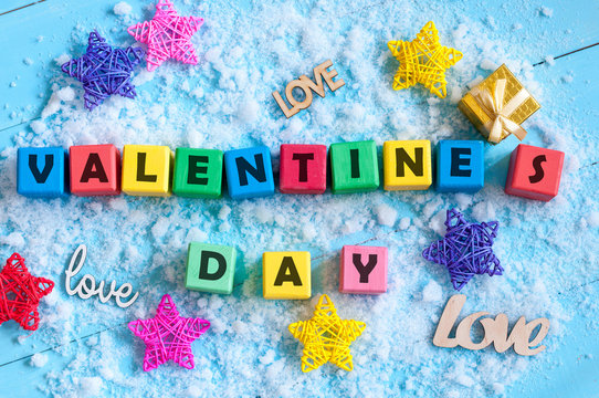 Valentines Day background with tiy cubes, srar and gift. Love, wedding concept