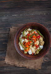 plate of rice with vegetables on a rustic background