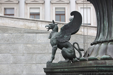 A griffin sculpture before the parliament building in Vienna, Austria.
