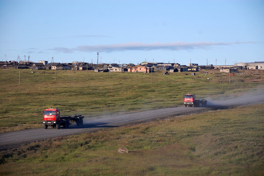 Trucks at gravel road abandoned town Chukotka