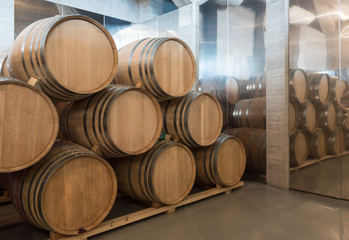 Wine barrels stacked in the basement cellar of a winery