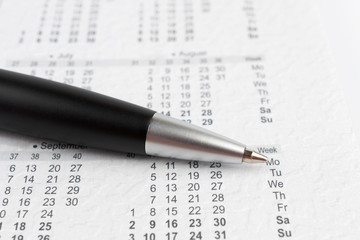 Black ballpoint pen on a calendar
