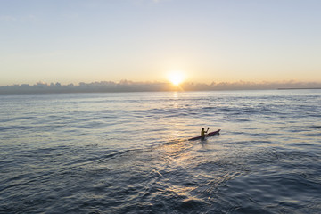 Fototapeta premium Paddler Surf-Ski Craft sunrise paddling training session sunrise ocean waters.