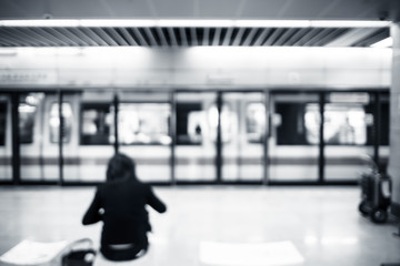 Blurred background, people waiting train at subway station with