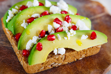 Avocado with Feta, pomegranate on sunflower seeds bread sandwich