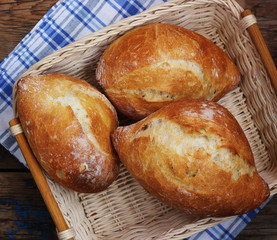 Fresh French rolls in a basket, the top view.