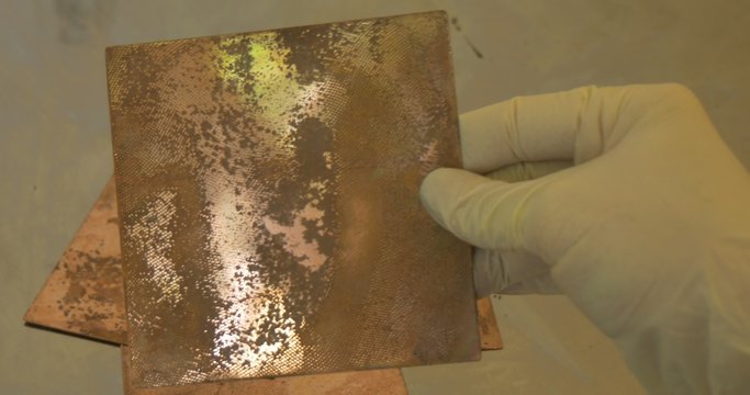 Man's Hands in Protective Gloves Are Holding The Copper Plates with Engraved Images of a Little Girl Process of Greating an Engraved Picture
