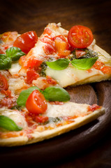 fresh homemade pizza with mozzarella and cherry tomatoes and Basil