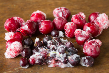 Frozen cherries and black currant on ice