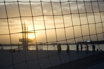 Sunset Beach volleyball.  Beach volleyball players silhouetted at sunset with ocean setting