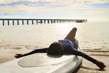 Summer Relaxation. Healthy Happy Woman With Fit Body Relaxing On Beach, Lying On SUP, Surf Board...
