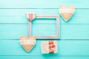 Romantic frame with copy space and accessories on blue wooden background. 