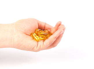 Fototapeta premium Evening primrose oil capsule in a hand,supplementa ry food.