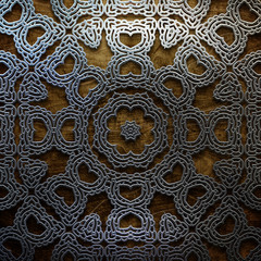 Metal ornament on old wooden background. Vintage collection