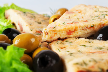 Slices of omelette with olives