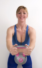 Woman using a 2 kg weight kettle bell to exercise