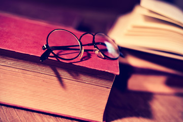 old eyeglasses and books, filtered
