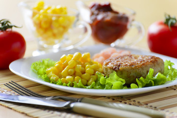 Cutlets with canned corn and peeled shrimp.