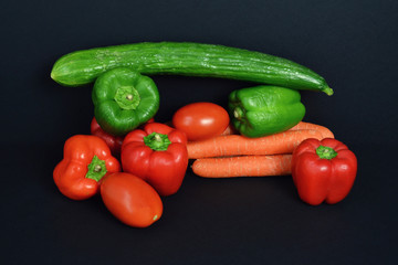 A pepper Assortment with tomato, carrot and cucumber.