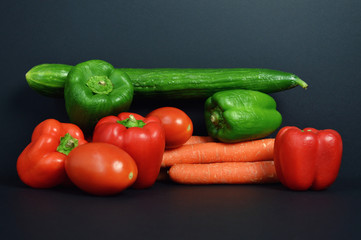 A pepper Assortment with tomato, carrot and cucumber.